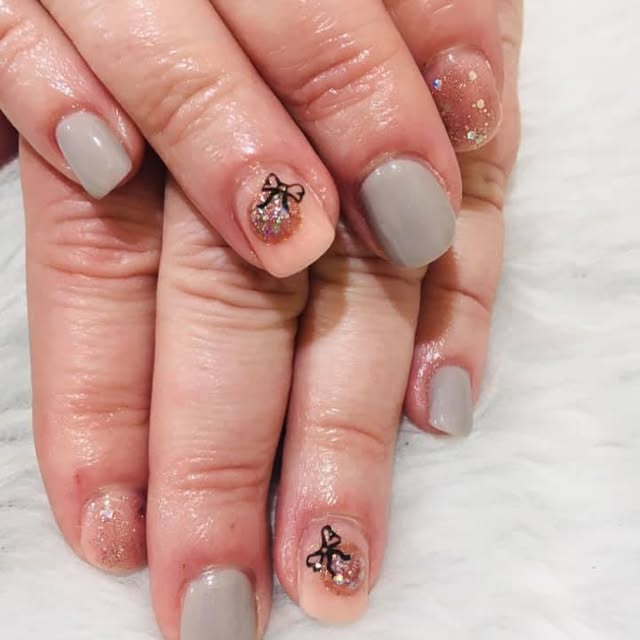Soft grey nails with tiny black bows