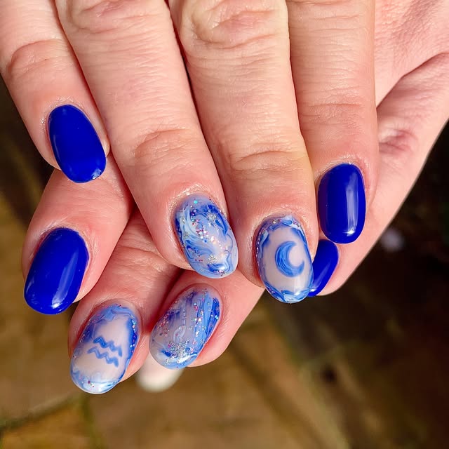 Blue swirl nails with a hand painted moon