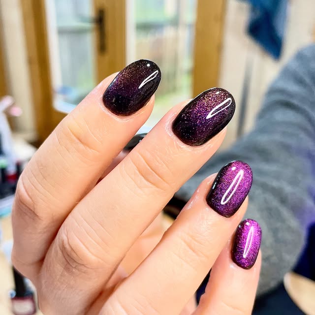 Purple and black glitter cat-eye ombre nails